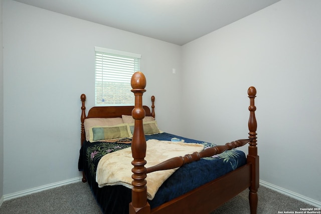 carpeted bedroom featuring baseboards