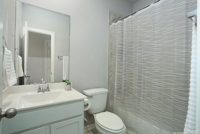 full bath featuring curtained shower, vanity, and toilet