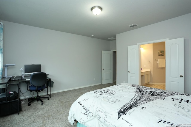 bedroom featuring carpet floors, visible vents, baseboards, and ensuite bathroom