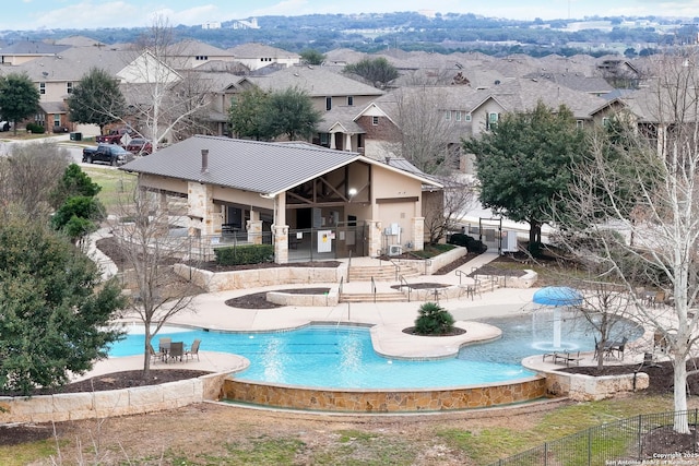 back of property featuring a patio area, a residential view, and a standing seam roof