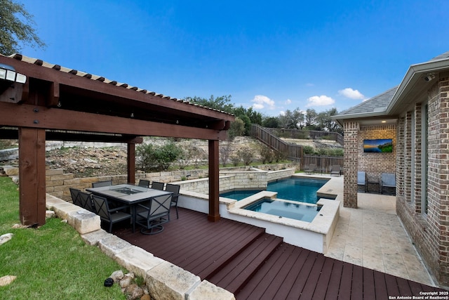 view of swimming pool featuring a fenced backyard and a pool with connected hot tub