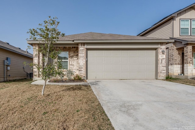 view of front facade featuring concrete driveway, brick siding, an attached garage, and a front yard