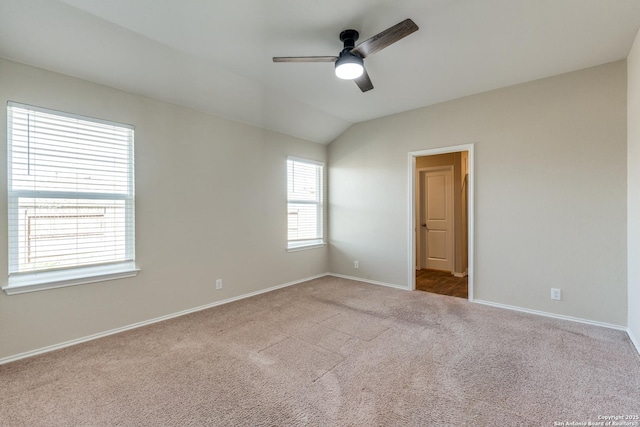 unfurnished room with carpet floors, lofted ceiling, ceiling fan, and baseboards