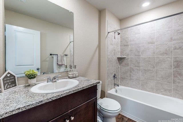 bathroom with toilet, vanity, and shower / bathtub combination