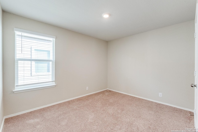 carpeted spare room with baseboards