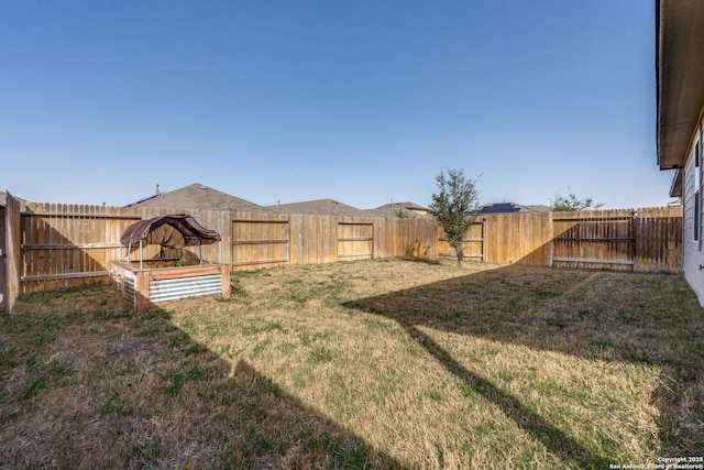 view of yard with a fenced backyard