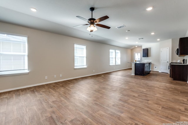 unfurnished living room featuring recessed lighting, visible vents, and wood finished floors