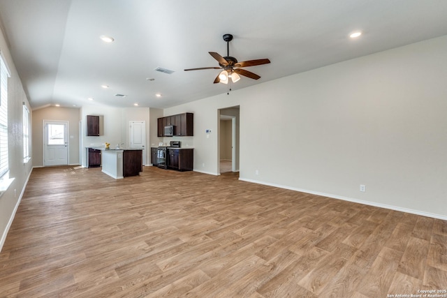 unfurnished living room featuring lofted ceiling, ceiling fan, light wood-type flooring, and recessed lighting