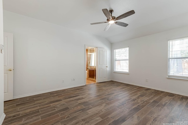 unfurnished room featuring a ceiling fan, baseboards, vaulted ceiling, and dark wood-type flooring