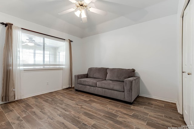 sitting room with baseboards, ceiling fan, and wood tiled floor