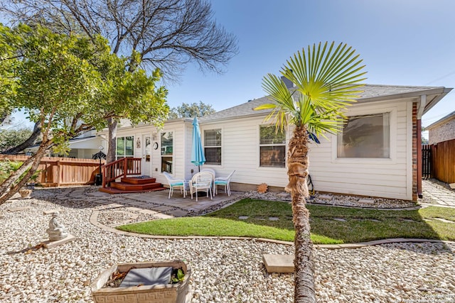 back of property with a patio area and fence