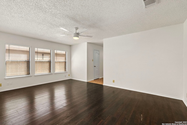 empty room with ceiling fan, a textured ceiling, wood finished floors, visible vents, and baseboards