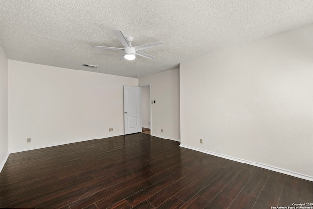 empty room with visible vents, dark wood-type flooring, ceiling fan, a textured ceiling, and baseboards