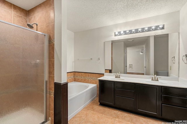 full bathroom featuring tile patterned flooring, a sink, and a shower stall