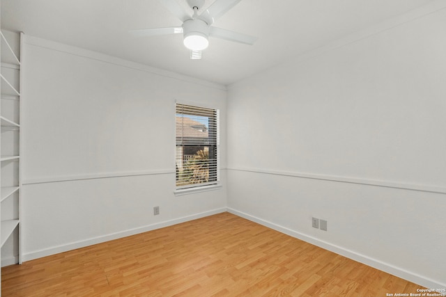 empty room featuring light wood-type flooring, a ceiling fan, and baseboards