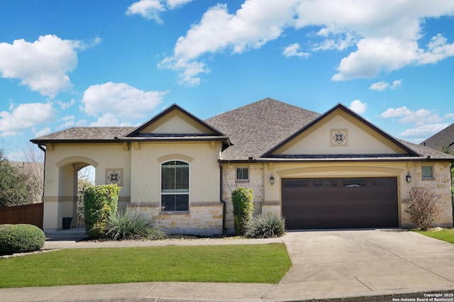 view of front of home featuring an attached garage, a front lawn, stone siding, stucco siding, and driveway