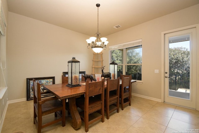 dining space featuring light tile patterned floors, visible vents, baseboards, and an inviting chandelier