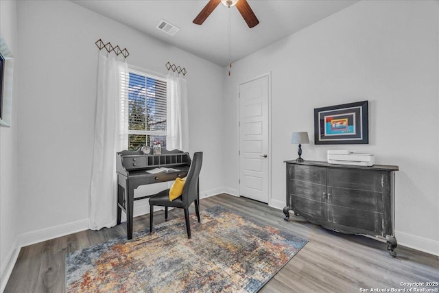 office featuring ceiling fan, wood finished floors, visible vents, and baseboards