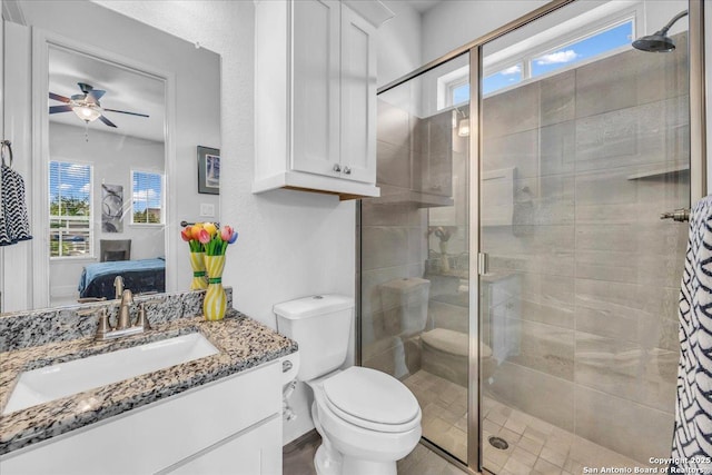 bathroom featuring a ceiling fan, connected bathroom, toilet, vanity, and a shower stall