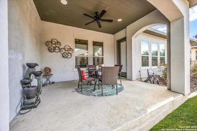 view of patio / terrace with outdoor dining area and a ceiling fan