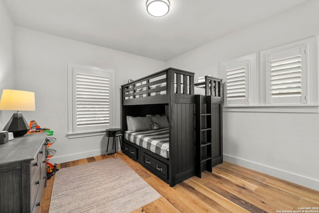 bedroom with light wood-style floors and baseboards