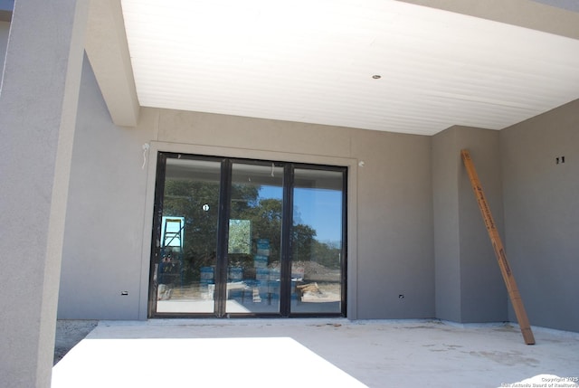 entrance to property with stucco siding