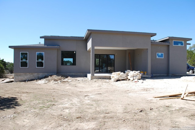 back of property with stucco siding