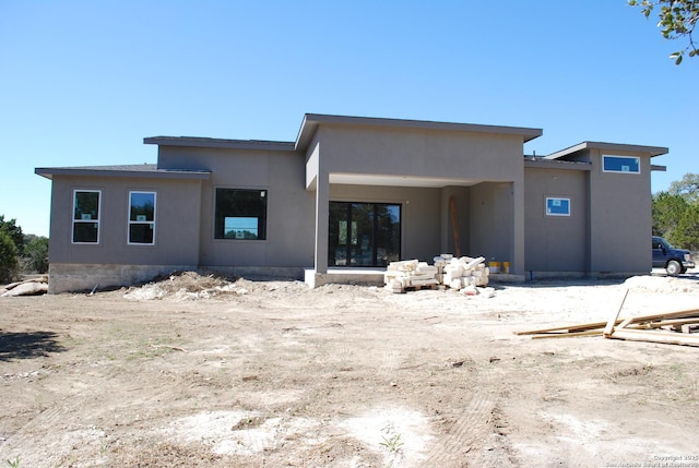 back of property with stucco siding