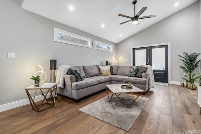 living room with baseboards, ceiling fan, wood finished floors, high vaulted ceiling, and recessed lighting