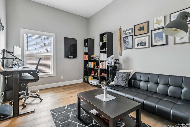 home office with baseboards and wood finished floors