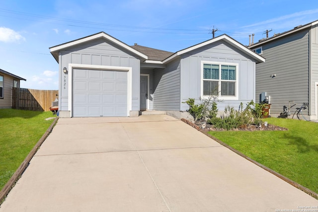 ranch-style house with an attached garage, board and batten siding, fence, driveway, and a front lawn