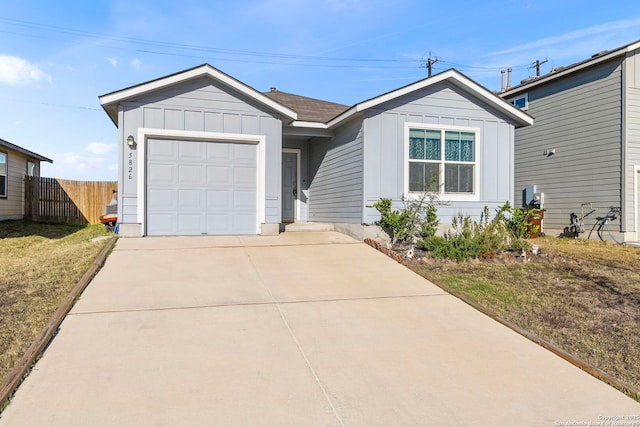 ranch-style home featuring driveway, an attached garage, fence, board and batten siding, and a front yard