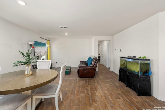 dining area with recessed lighting, wood finished floors, visible vents, and baseboards