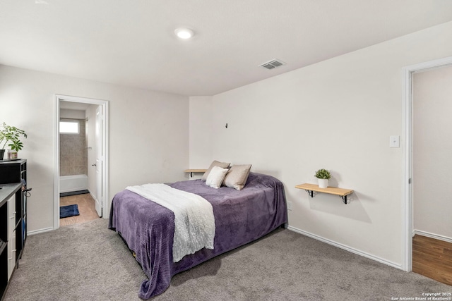 bedroom featuring baseboards, visible vents, carpet flooring, and ensuite bathroom