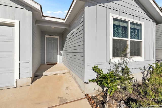 view of exterior entry featuring a garage