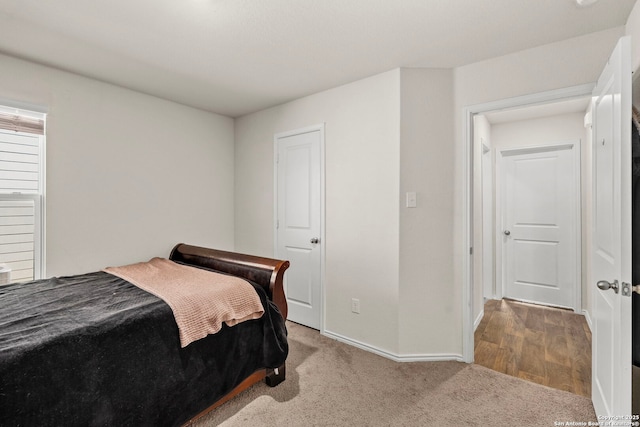 carpeted bedroom featuring baseboards