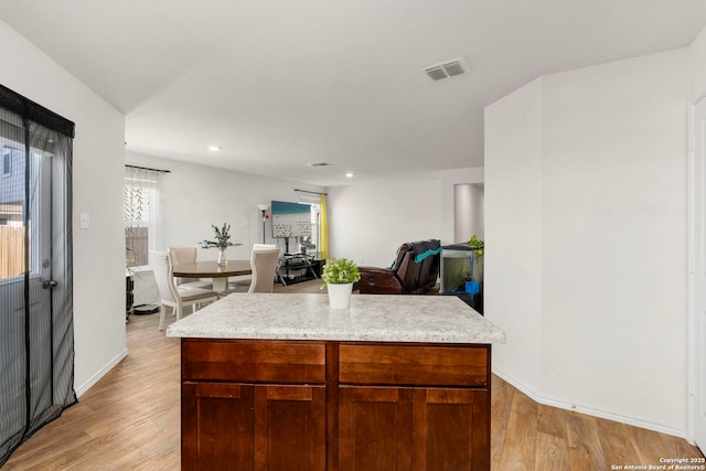 kitchen featuring light wood finished floors, recessed lighting, visible vents, and baseboards