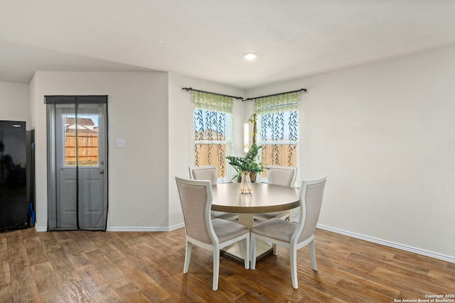 dining room featuring wood finished floors and baseboards