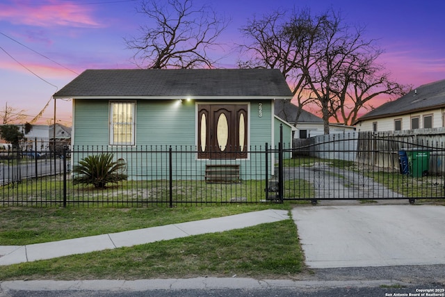 bungalow-style home featuring a fenced front yard and a gate