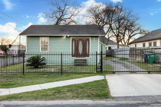 bungalow with a fenced front yard, a front yard, and a gate