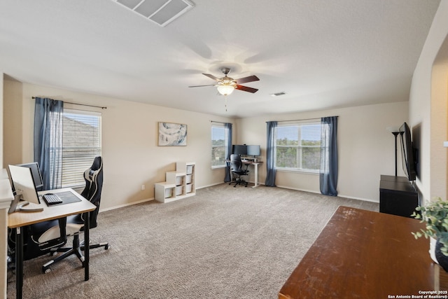 carpeted office featuring visible vents, ceiling fan, and baseboards