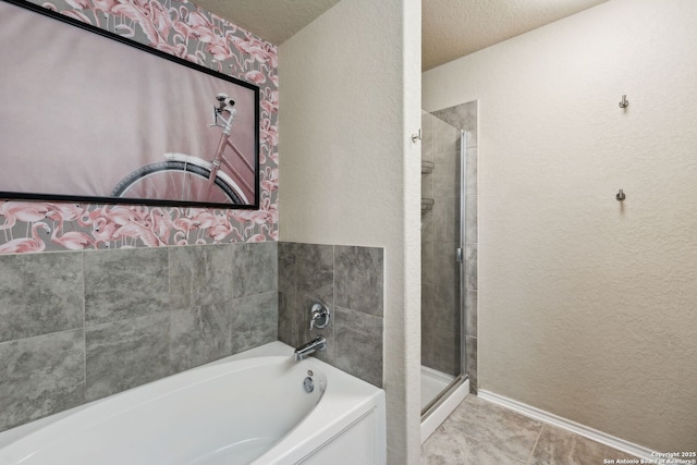 bathroom with a textured ceiling, a textured wall, a garden tub, tile patterned floors, and a stall shower