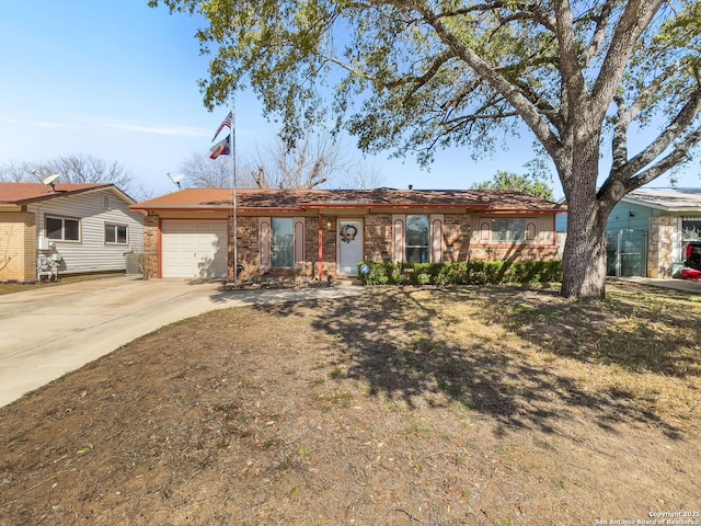 single story home with brick siding, driveway, and an attached garage