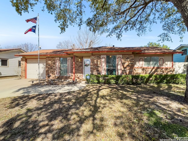 ranch-style house with concrete driveway, brick siding, and an attached garage