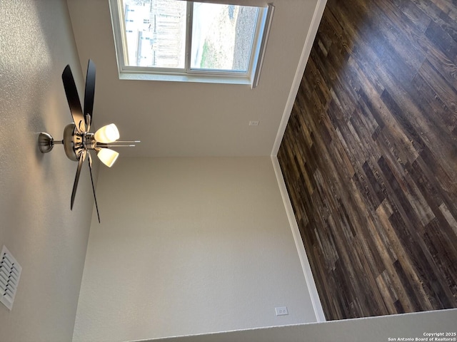 unfurnished room featuring visible vents and a ceiling fan