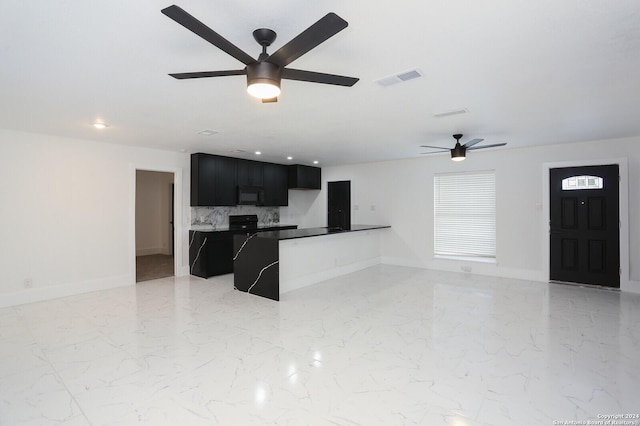 kitchen with black microwave, dark cabinets, visible vents, open floor plan, and marble finish floor