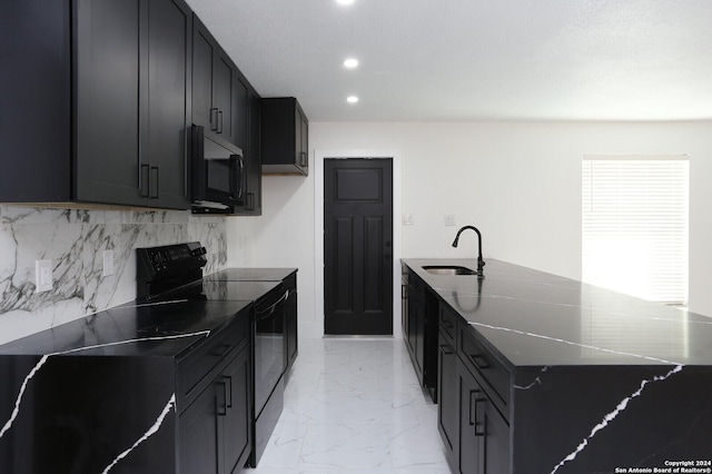 kitchen featuring marble finish floor, black appliances, a sink, and dark cabinets