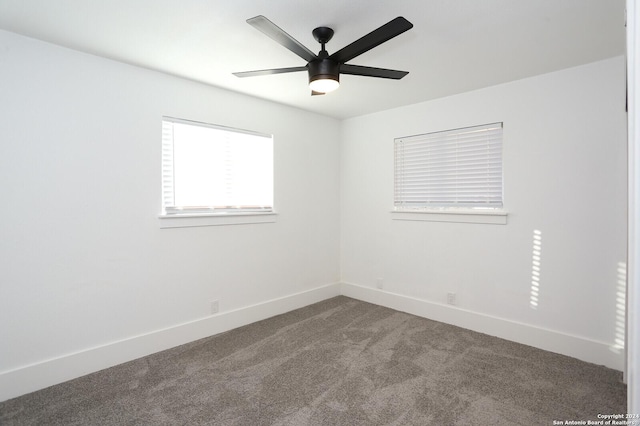 spare room featuring carpet floors, baseboards, and a ceiling fan