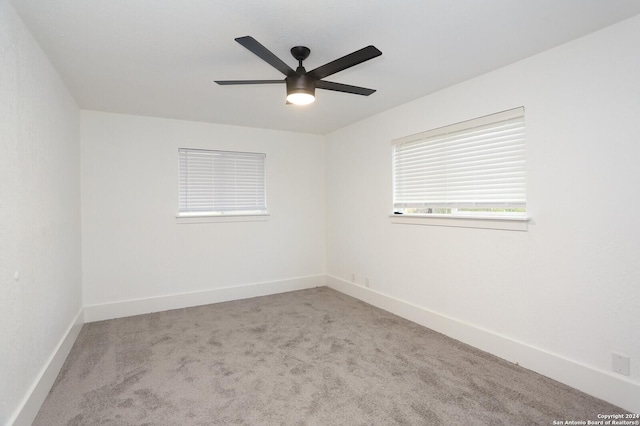 unfurnished room featuring carpet, baseboards, and a ceiling fan