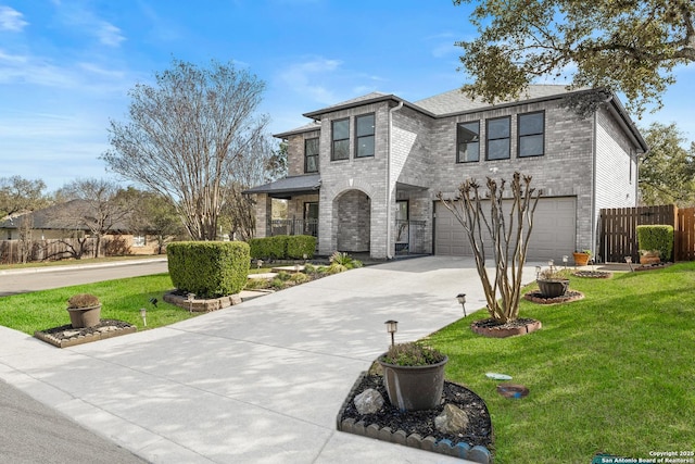 view of front of property with a garage, concrete driveway, fence, a front lawn, and brick siding